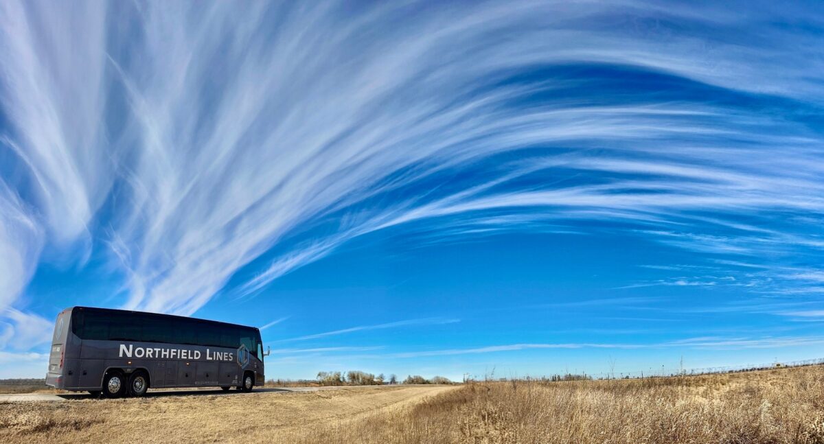 Northfield lines bus on road with clouds above